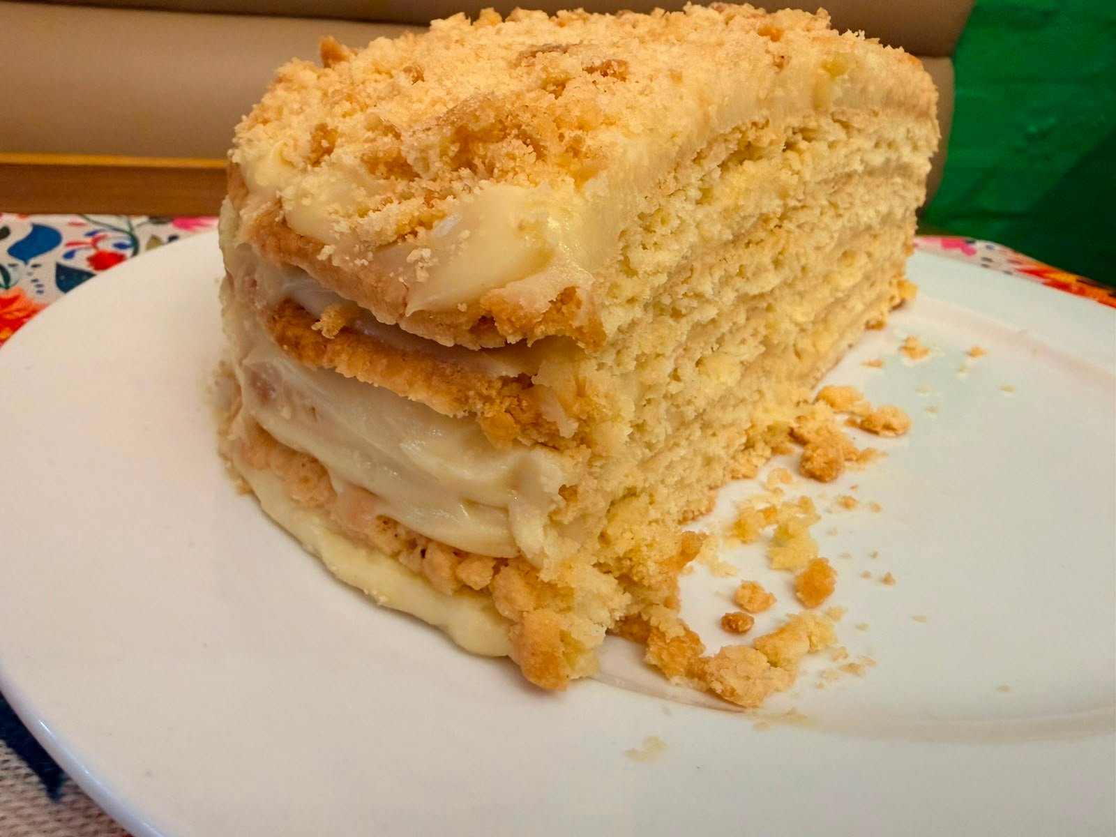 A slice of layered melktert on a plate