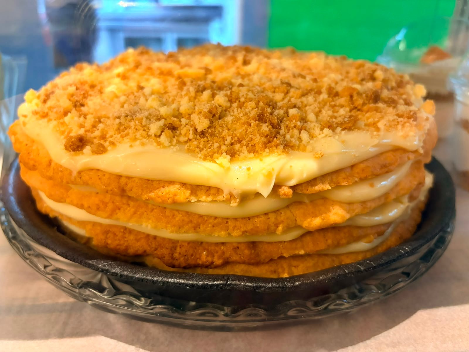 A whole layered melktert dusted with cinnamon